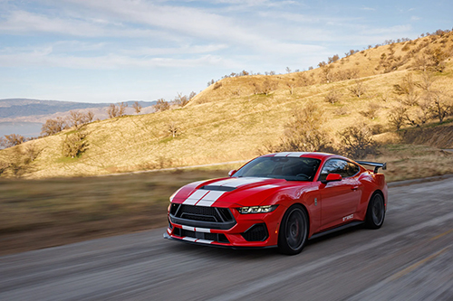 Red Shelby GT350 driving down car | Dale Adams Automotive Specialists