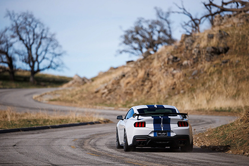 White Shelby GT350 driving away | Dale Adams Automotive Specialists